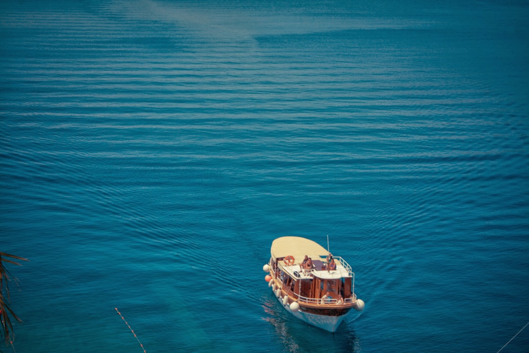 a-boat-floating-on-top-of-a-large-body-of-water-yCpsJtWBE6E.jpg