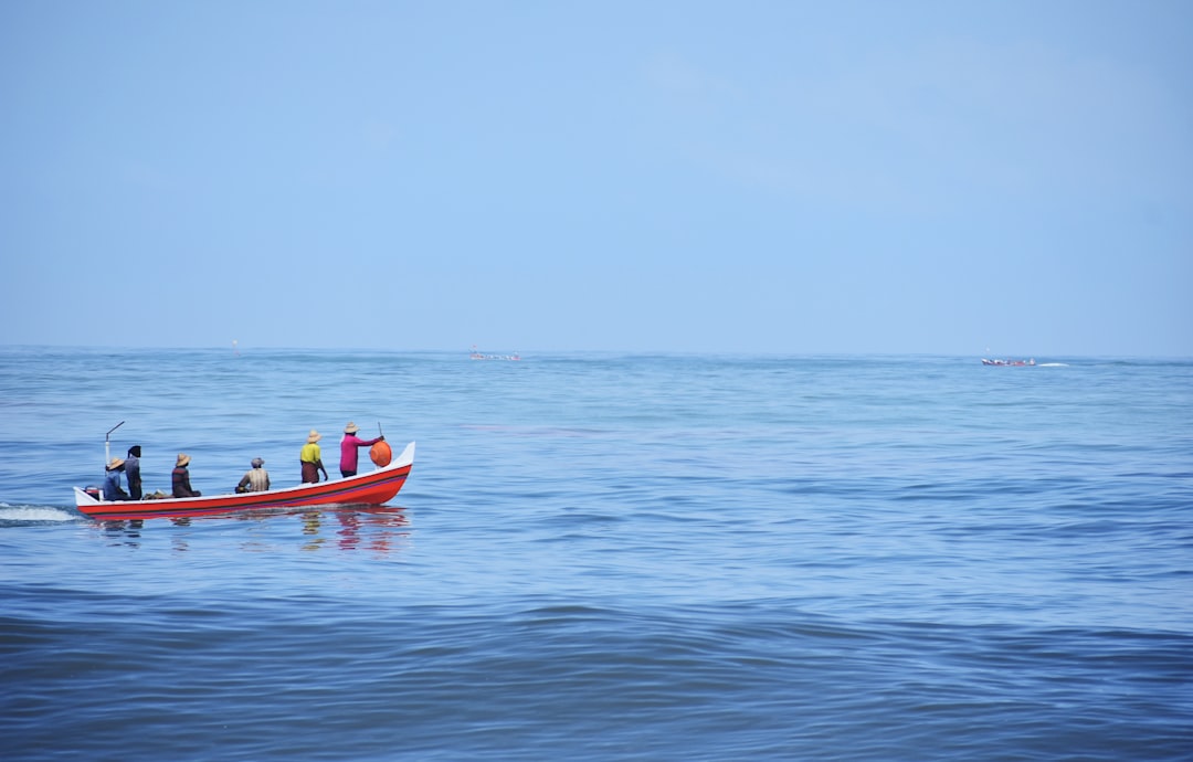 a-group-of-people-on-a-boat-in-the-ocean-WAc_d_MpALI.jpg