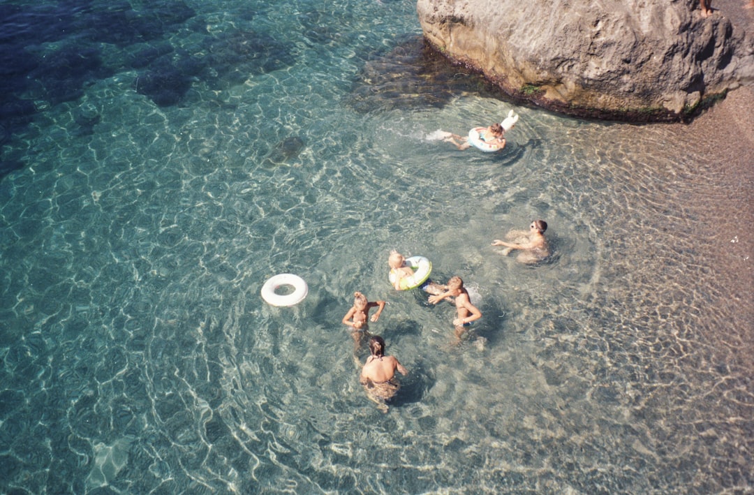 people-swimming-on-body-of-water-during-daytime-2nkkMkV_ypA.jpg