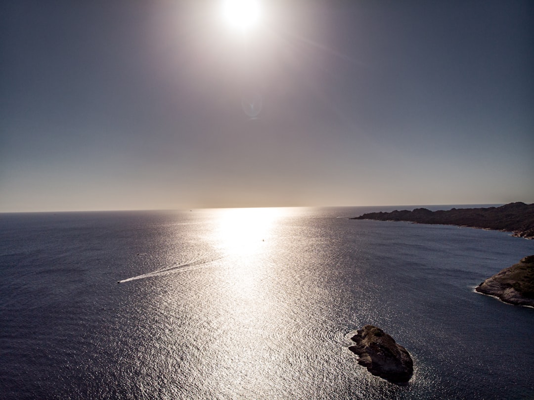 the-sun-is-shining-over-a-body-of-water-Bs3zLkCuzUk.jpg